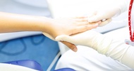 Kosmetikgerät wird auf dem Handrücken einer Person angewendet
